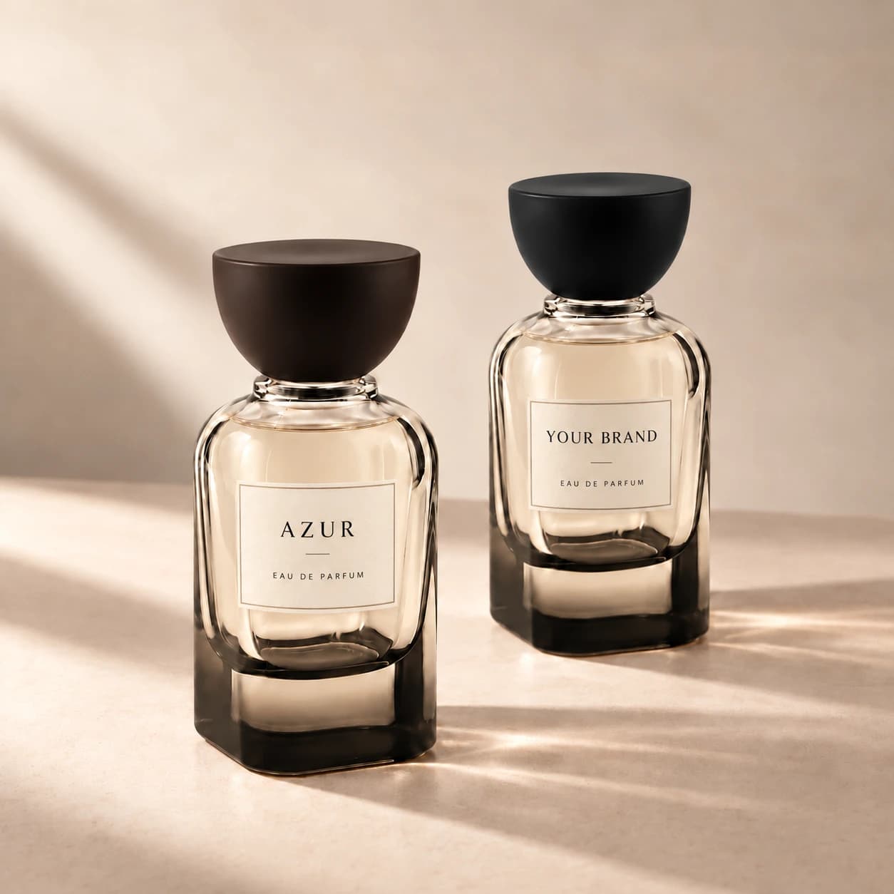 Two glass perfume bottle shapes with dark caps, Azur and Your Brand artwork